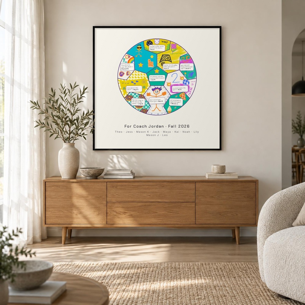 The finished soccer ball mural, framed in black, hanging above a wooden sideboard.